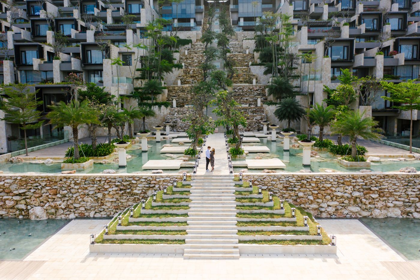 Couple walking through a luxury resort garden