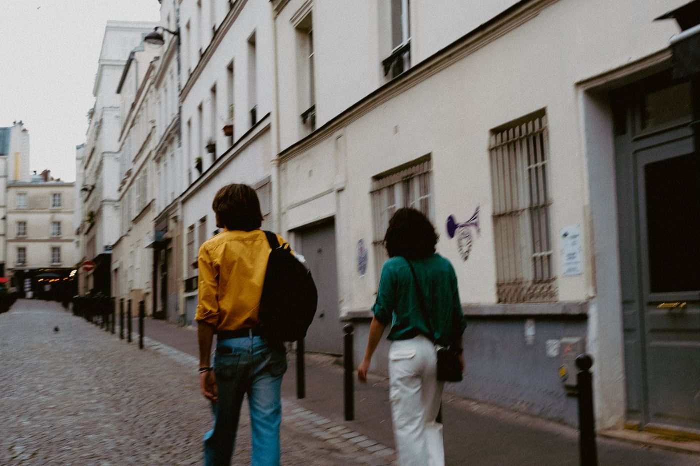 Couple walking a cobblestone street in southern France