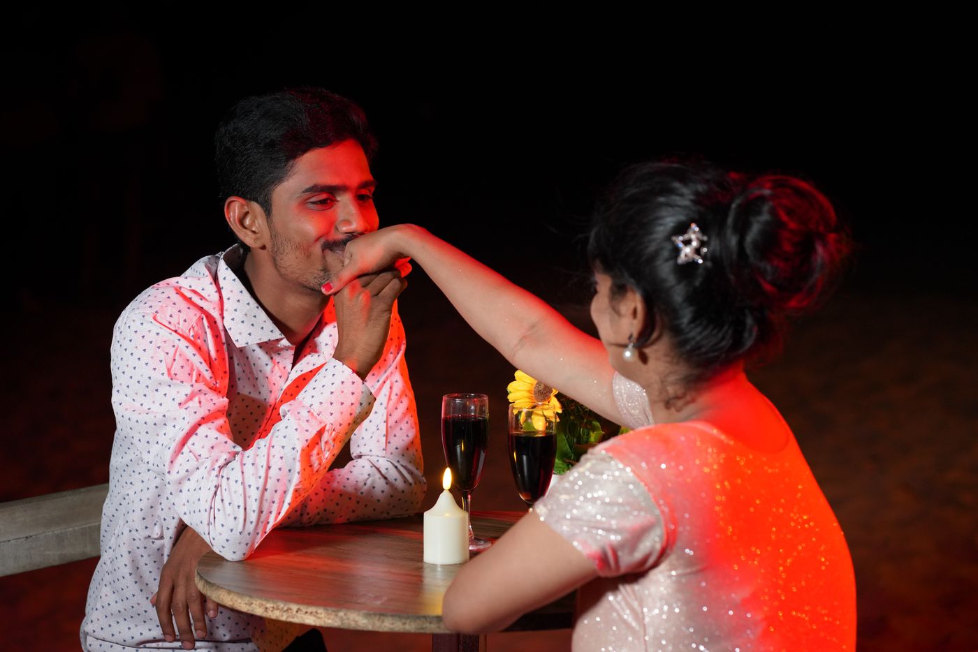 Couple sharing a candlelit dinner with wine
