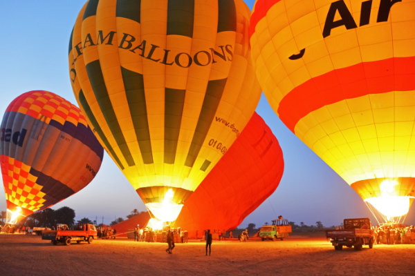 Hot-air balloons rising over Luxor at sunrise